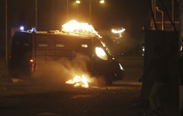 A protester, opposing Egyptian President Mohamed Mursi, throws a Molotov cocktail at a riot police vehicle during clashes in front of the Security Directorate in Port Said, March 5, 2013. Source: REUTERS/Amr Abdallah Dalsh