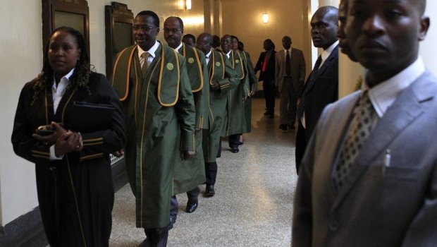 Supreme Court judges walk back after a break on the last day of the presidential poll petition in Kenya's capital Nairobi March 28, 2013. REUTERS/Noor Khamis