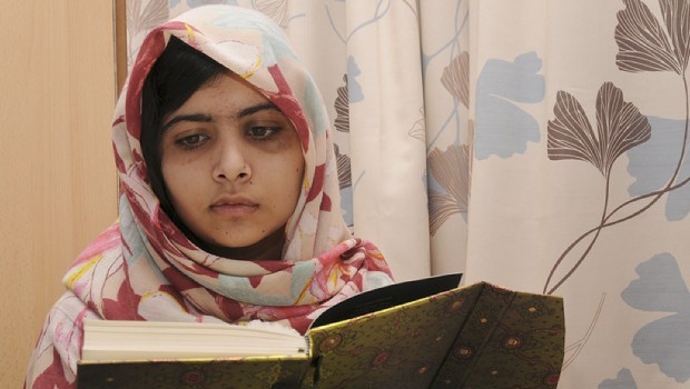A handout picture taken on November 7, 2012, and obtained from the Queen Elizabeth Hospital in Birmingham on November 9, 2012, shows injured 15 year-old Pakistani schoolgirl Malala Yousafzai reading a book at the Queen Elizabeth Hospital in Birmingham in central England.  (AFP PHOTO)