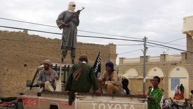 In this Aug. 31, 2012 file photo, fighters from the al-Qaida-linked Islamist group Ansar Dine stand guard in Timbuktu, Mali. (AP Photo, File)