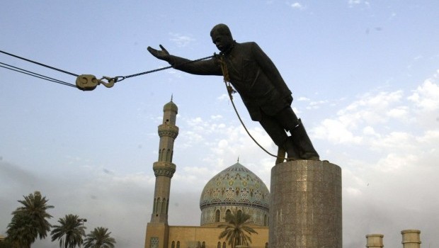 A U.S. Marine watches a statue of Saddam Hussein being toppled in Firdaus Square in downtown Baghdad on April 9, 2003 file photo. (AP Photo/Jerome Delay, File)