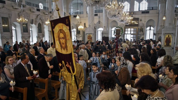 In this Sunday, April 15, 2012 file photo, Syrian Orthodox Christians attend Easter mass in Damascus, Syria. (AP Photo/Bassem Tellawi, File)