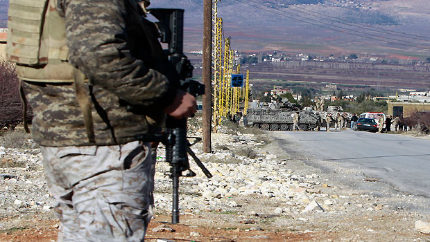 Lebanese army soldiers search civilians at one of their checkpoints at the entrance of Arsal, a Sunni Muslim town in eastern Lebanon near the Syrian border, Saturday, Feb. 2, 2013. (AP)