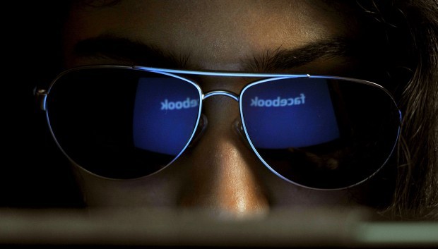 The ‘Facebook’ logo is reflected in a young woman’s sunglasses. (Manjunath Kiran/AFP/Getty Images)