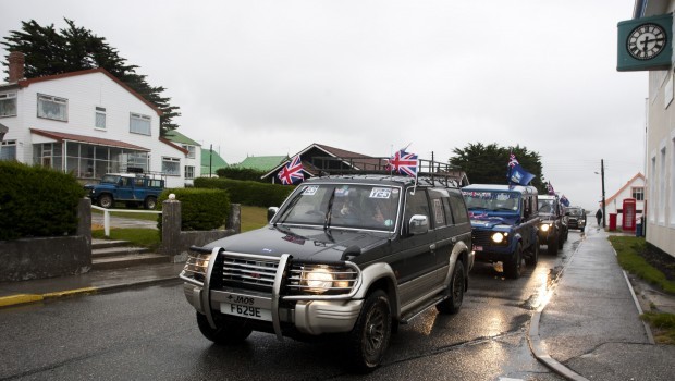 People drive their vehicles bearing British flags and stickers in favor of keeping the Falkland Islands as an overseas territory of the United Kingdom in Port Stanley, Falkland Islands, Saturday, March 9, 2013. (AP Photo/Paul Byrne)