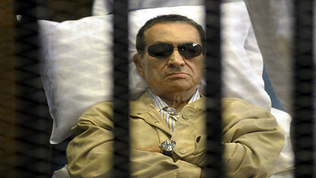 In this Saturday, June 2, 2012 file photo, Egypt's former President, Hosni Mubarak, lays on a gurney inside a barred cage in the police academy courthouse in Cairo, Egypt. (AP)