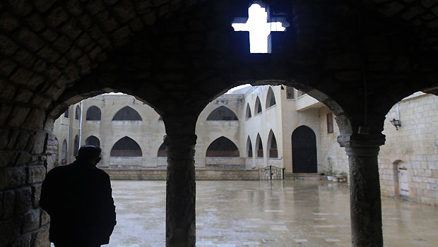A Syrian Christian stands at the entrance to a monastery in Mishtaya. (Louai Beshara/AFP/Getty Images) 