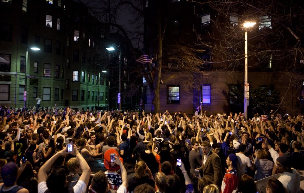 An estimated 200 people pour onto Hemingway Street in the Fenway neighborhood to celebrate after the announcement earlier of the capture of the second Boston Martathon bombing suspect celebrate April 19, 2013 in Boston, Massachusetts. (Kayana Szymczak/Getty Images/AFP) 