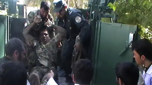 This image made from AP video shows an injured Afghan National Army soldier taken off from a military vehicle outside the local hospital in Farah, western Afghanistan, Wednesday, April 3, 2013 (AP Photo via AP video)
