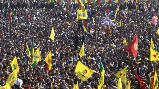 Demonstrators hold Kurdish flags and flags with portraits of the jailed Kurdistan Workers Party (PKK) leader Abdullah Ocalan during a gathering to celebrate Newroz in the southeastern Turkish city of Diyarbakir March 21, 2013. Source: REUTERS/Umit Bektas
