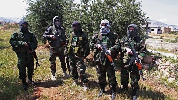 Members of the Lebanese pro-Syrian Popular Committees pose for a photograph at the Lebanon-Syria border, near the northeastern Lebanese town of al-Qasr, Lebanon on Friday, April 12, 2013 (AP Photo/Bilal Hussein)