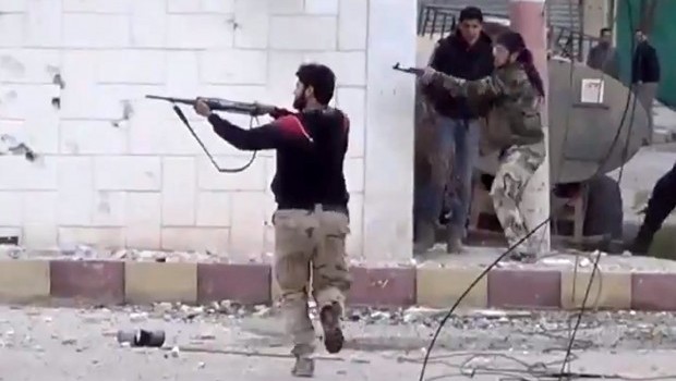 In this Monday March 18, 2013 file image taken from video obtained from the Shaam News Network, which has been authenticated based on its contents and other AP reporting, shows free Syrian Army fighters fire at Syrian army soldiers during a fierce firefight in Daraa al-Balad, Syria (AP Photo/Shaam News Network via AP video, File)