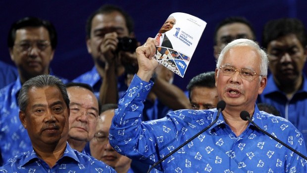 Malaysian Prime Minister Najib Razak holds a booklet on his party's manifesto for the upcoming general elections. Kuala Lumpur, Saturday April 6, 2013. Source: AP Photo/Lai Seng Sin