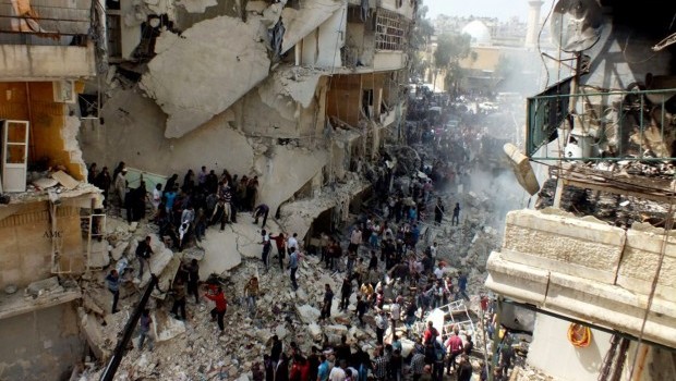 Syrian citizens searching for bodies in the rubble of damaged buildings that were attacked by Syrian forces airstrikes in the Al-Ansari neighborhood of Aleppo, Syria. Source: AP Photo/Aleppo Media Center AMC