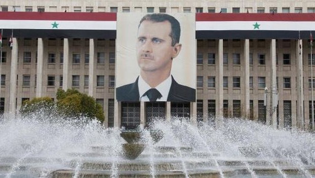 A picture of Syria's President Bashar al-Assad is seen on the central bank building in Damascus, in this February 24, 2012 file photo. (REUTERS)