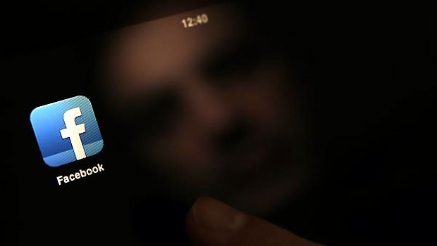 A man uses an iPad with a Facebook app in this photo illustration in Sofia January 30, 2013. (R)