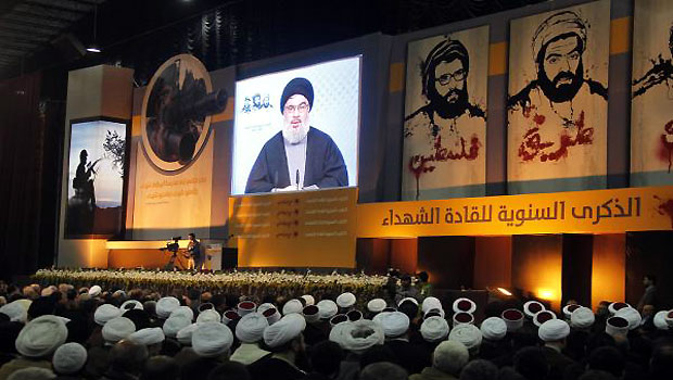 Shi'ite, Sunni Muslim and Druze Lebanese clerics listen to Lebanon's Hezbollah leader Sayyed Hassan Nasrallah addressing his supporters during a rally to commemorate Martyrs' Day in Beirut. (R)