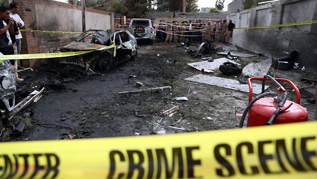 Police tape closes the site of a car bomb that targeted the French embassy wounding two French guards and causing extensive material damage in Tripoli, Libya, on Tuesday, April 23, 2013. (AP)