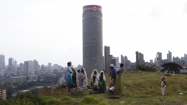 Worshippers offer prayers for Easter and former South African president Nelson Mandela a top of a hill overlooking Johannesburg, Saturday, March 30, 2013. Source: AP Photo/Denis Farrell