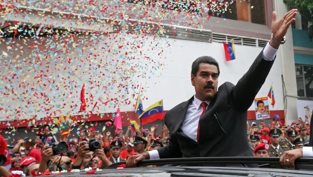 Venezuela's president, Nicolas Maduro, waves to supporters as he arrives at the national Assembly for his inaugural ceremony in Caracas, Venezuela, on Friday, April 19, 2013. (AP Photo/Gil Montano)