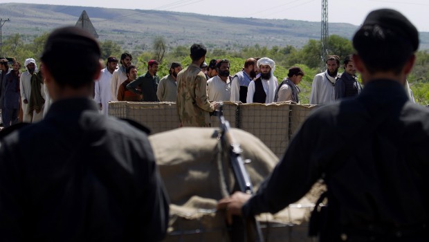 Tribal villagers stand at an army checkpoint in Tank, the border town of South Waziristan, the Pakistani tribal area bordering Afghanistan. Source: AP Photo/B. K. Bangesh