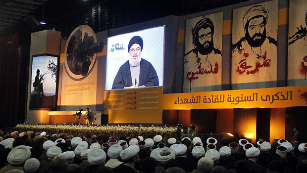 Shi'ite, Sunni Muslim and Druze Lebanese clerics listen to Lebanon's Hezbollah leader Sayyed Hassan Nasrallah addressing his supporters during a rally to commemorate Martyrs' Day in Beirut. (R)