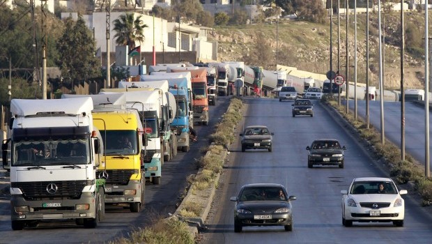 Tanker trucks form a queue as they wait to unload crude oil at a refinery. (REUTERS/Muhammad Hamed)