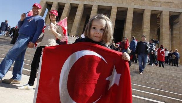 A girl holds a Turkish national flag as she visits the mausoleum of Ataturk, founder of modern Turkey, in Ankara. (REUTERS)