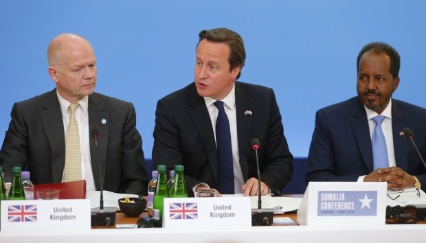 Britain's Prime Minister David Cameron, center, sits with Britain's Foreign Secretary William Hague, left, and Somali President Hassan Sheikh Mohamud as he speaks at the Somalia conference in London, Tuesday May 7, 2013. (AP Photo/Andrew Winning, Pool)