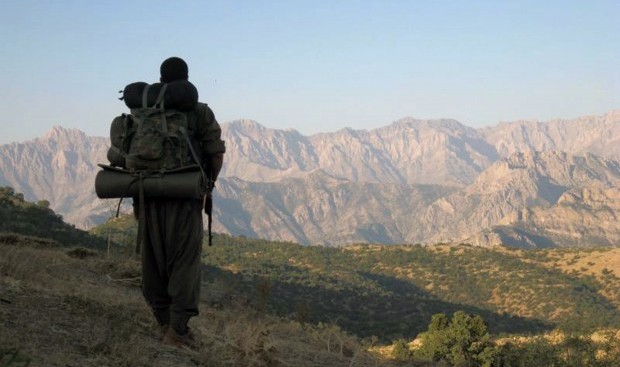 This photo taken on Tuesday May 7, 2013 and provided by Firat News Agency on Wednesday May 8, 2013 shows a rebel of the Kurdistan Workers Party, or PKK, in Turkey close to the border with Iraq. (AP Photo/Firat News Agency)