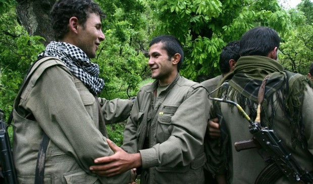 Kurdish fighters from the Kurdistan Workers Party (PKK) congratulate each other after arriving in the Heror area, northeast of Dahuk, 260 miles (430 kilometers) northwest of Baghdad, Iraq, Tuesday, May 14, 2013. (AP Photo/ Ceerwan Aziz)