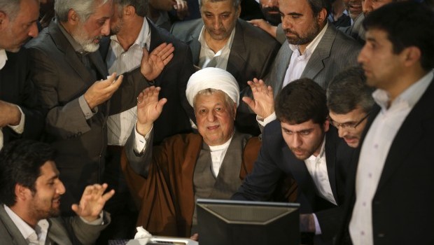 Former Iranian President Akbar Hashemi Rafsanjani, 78, waves to media, as he registers his candidacy for the upcoming presidential election, at the election headquarters of the interior ministry in Tehran, Iran, on May 11, 2013 (AP Photo/Ebrahim Noroozi, File)