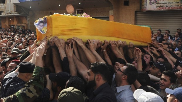 Supporters of Hezbollah and relatives of Hasan Faisal Sheker, an 18-year-old Hezbollah member, carry the coffin during his funeral in Nabi Sheet near Baalbeck May 20, 2013. Several Lebanese Hezbollah fighters and 20 Syrian soldiers and militiamen loyal to President Bashar Al-Assad have been killed in the fiercest fighting this year in the rebel stronghold of Qusair, Syrian activists said on Monday (REUTERS/Stringer)