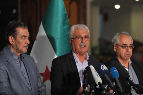 President of the Syrian National Council (SNC) George Sabra (C) and members of Syrian National Council attend a press conference at the end of Syrian Opposition meeting on May 30, 2013 in Istanbul. Syria's main opposition group said it will not take part in proposed US-Russia peace talks while key allies of President Bashar al-Assad's regime are waging war alongside government forces. AFP PHOTO / OZAN KOSE