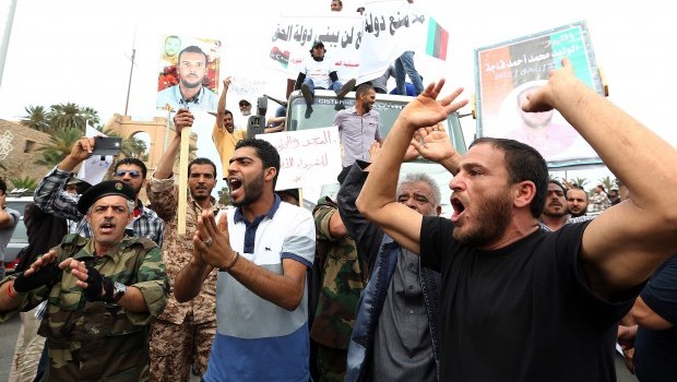 Libyan protesters hold placards and banners during a demonstration in support of the "political isolation law" banning Gaddafi-era officials in Libya's landmark Martyrs Square on May 5, 2013 in Tripoli, Libya (AFP PHOTO/MAHMUD TURKIA)