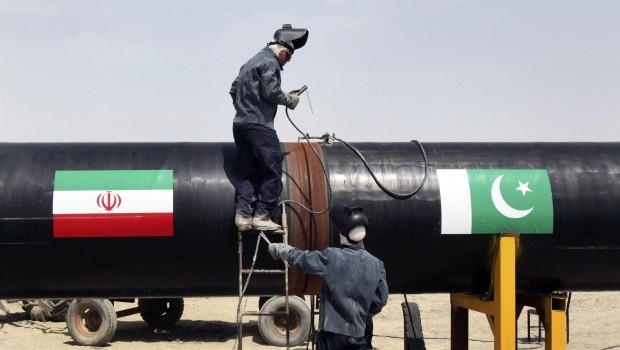 Iranian workers weld two gas pipes together at the start of construction on a pipeline to transfer natural gas from Iran to Pakistan, in Chabahar, southeastern Iran, near the Pakistani border, Monday, March 11, 2013. Source: AP Photo/Vahid Salemi