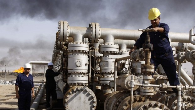 In this Dec. 13, 2009 file photo, Iraqi laborers work at the Rumaila oil refinery, near the city of Basra. Source: AP Photo/Nabil al-Jurani
