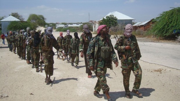 Members of Somalia's Al-Shabab militant group patrol on foot on the outskirts of Mogadishu in this  Monday, March, 5, 2012 file photo. The slaying of a British soldier in east London raised questions about the reach of the terrorist group al-Shabab, after a British government official said one of the two men tried to go to Somalia to train or fight with the group. Source: AP Photo