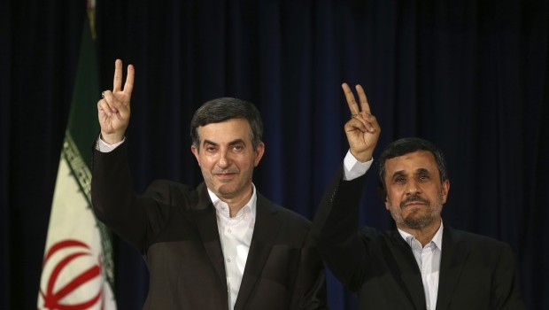 Iranian President Mahmoud Ahmadinejad, right, and his close ally Esfandiar Rahim Mashaei, flash victory signs at the start of their press conference, after registering candidacy of Rahim Mashaei for the upcoming presidential election, at the election headquarters of the interior ministry, in Tehran, Iran, Saturday, May 11, 2013 (AP Photo/Ebrahim Noroozi)