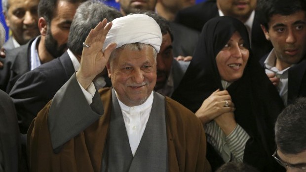 In this Saturday, May 11, 2013 photo, former President Akbar Hashemi Rafsanjani, waves to media, as he registers his candidacy for the upcoming presidential election, while his daughter Fatemeh, smiles at second right, at the election headquarters of the interior ministry in Tehran, Iran (AP Photo/Ebrahim Noroozi)