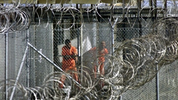 A file photograph showing men dressed in orange coveralls, alleged al-Qaida and Taliban combatants captured in Afghanistan washing before midday prayers at controversial Camp X-Ray, where they are being held in cages at the US Naval Base at Guantanamo Bay, Cuba, 27 January 2002. Source: EPA/J. Scott Applewhite/Pool