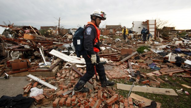 A member of Nebraska Task Force-1 walks through the rubble of a home along SW 6th Street in Moore, Okla., on Tuesday, May 21, 2013. Source: AP Photo/Brad Loper