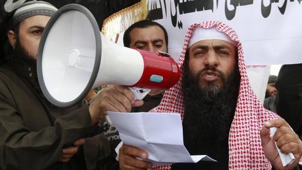Jordanian Salafi jihadi leader Abu Sayyaf speaks to his supporters and the media during a demonstration against prolonged detention of the group's leaders near the prime minister's office in Amman. (REUTERS/Muhammad Hamed)