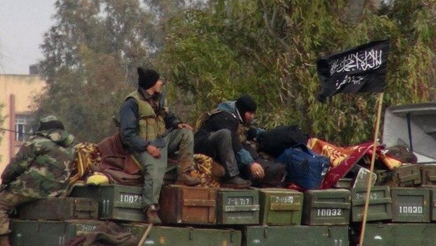 This Friday, January 11, 2013 file citizen journalism image provided by Edlib News Network (ENN), which has been authenticated based on its contents and other AP reporting, shows rebels from Al-Qaeda-affiliated Jabhat Al-Nusra as they sit on a truck full of ammunition in Idlib province, northern Syria. (AP Photo/Edlib News Network ENN, File)