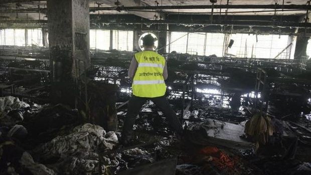 An investigator surveys the scene of a fire at a garment factory in Dhaka, Bangladesh, Thursday, May 9, 2013. (AP Photo)
