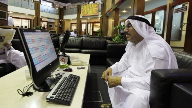 An investor monitors a stock exchange information screen on the trading floor at the Dubai Financial Market in this April 29, 2012 file photo. (REUTERS/Jumana El Heloueh/Files)