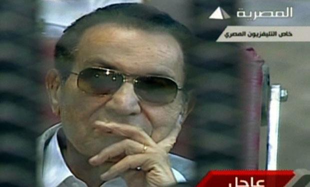 An image grab taken from Egyptian state TV shows ousted Egyptian president Hosni Mubarak sitting behind bars during his retrial at the Police Academy in Cairo on May 11, 2013. (AFP PHOTO/EGYPTIAN TV)