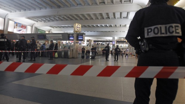 Police officers stand near the cordoned off spot where a French soldier was stabbed in the throat in the busy commercial district of La Defense, outside Paris, Saturday May 25, 2013, and France's president said authorities are investigating any possible links with the recent slaying of a British soldier. AP Photo/Remy de la Mauviniere
