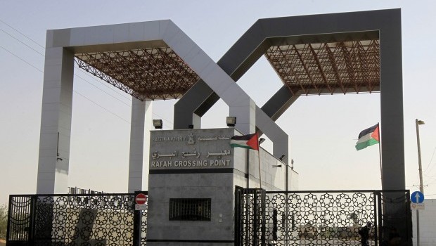 Palestinian flags flutter at the closed gate of the Rafah crossing with Egypt in the southern Gaza Strip on May 17, 2013. Source: AFP Photo/Said Khatib
