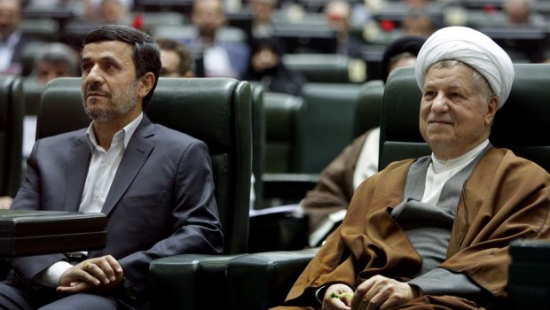 In this Sunday, May 27, 2012, file photo, former Iranian President Akbar Hashemi Rafsanjani, right, smiles, as he sits next to President Mahmoud Ahmadinejad, in an inauguration ceremony of the parliament in Tehran, Iran. (AP Photo/Vahid Salemi, File)